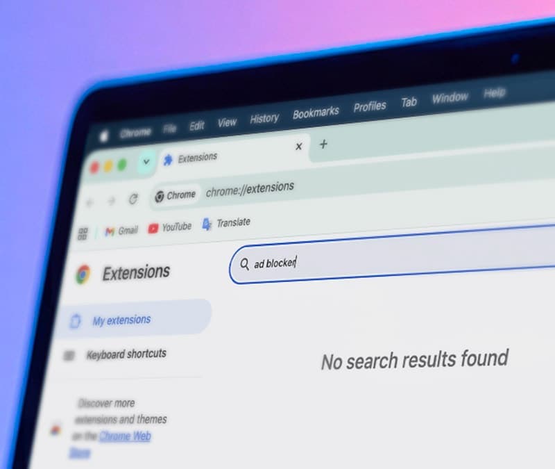 A laptop showing the Chrome extensions page with “ad blocker” typed into the search box and no results found.